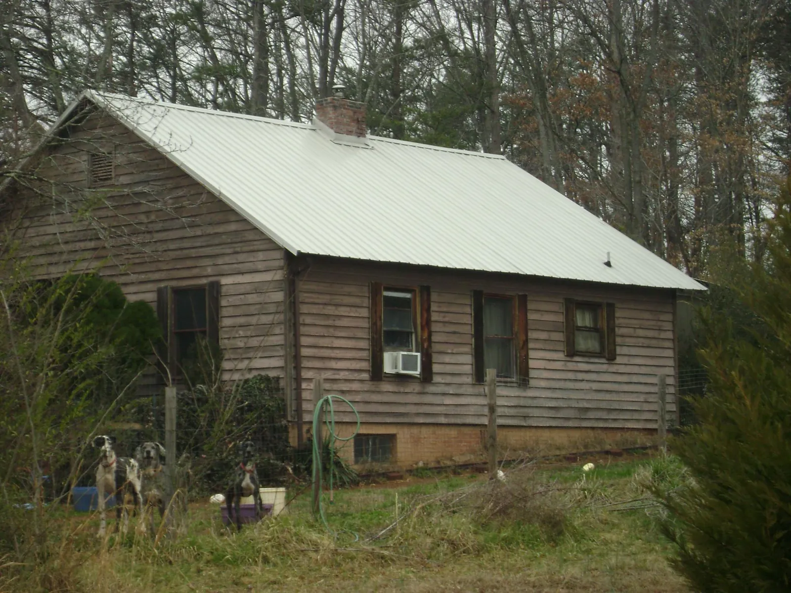 White metal roof on an old wood sided farmhouse, from a Metal Roof Installation job in Bernardston